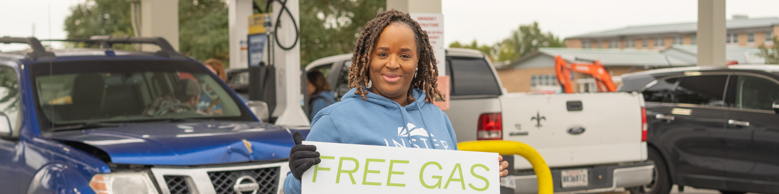 Instep staff member holding free gas sign